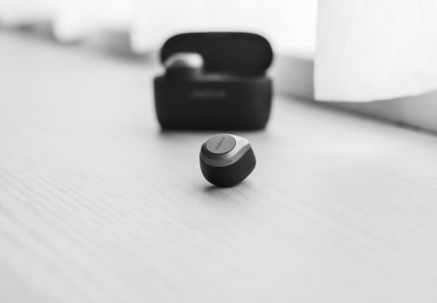 grayscale photo of a wireless earphone